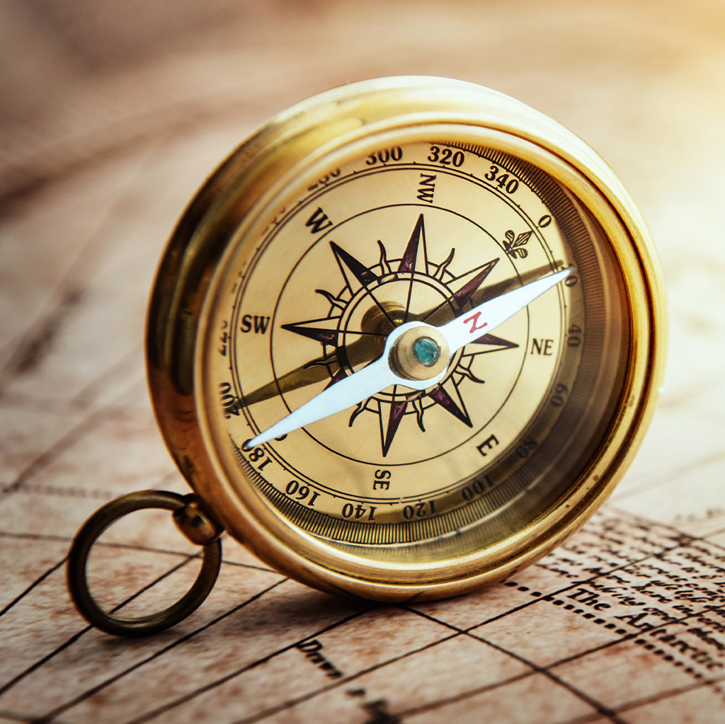 an antique compass laying on its side